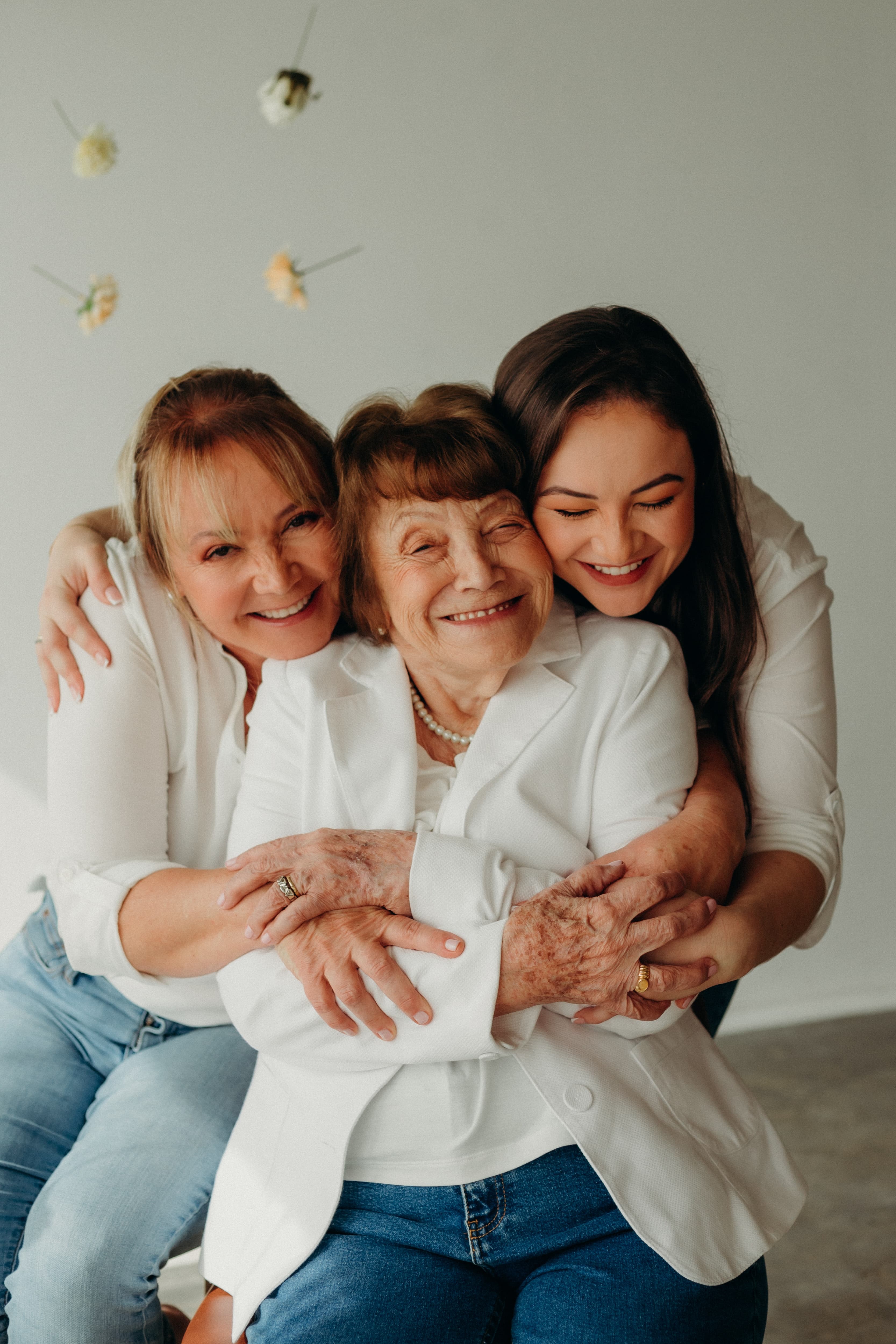 Two Women Hugging an Older woman Smiling